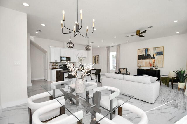 dining area featuring recessed lighting, visible vents, marble finish floor, and ceiling fan with notable chandelier