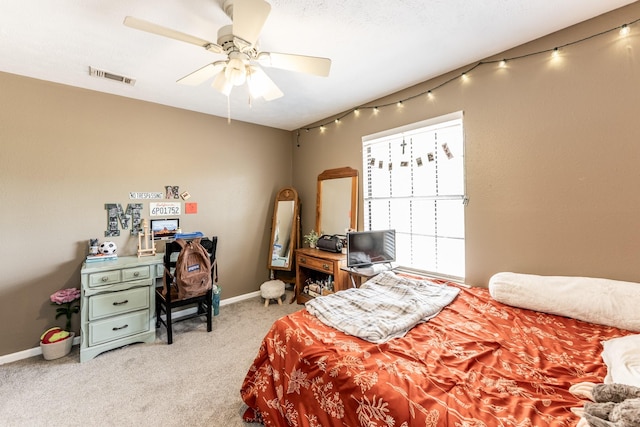 carpeted bedroom featuring a ceiling fan, baseboards, and visible vents