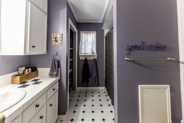 bathroom with a shower with curtain, tile patterned floors, crown molding, and vanity