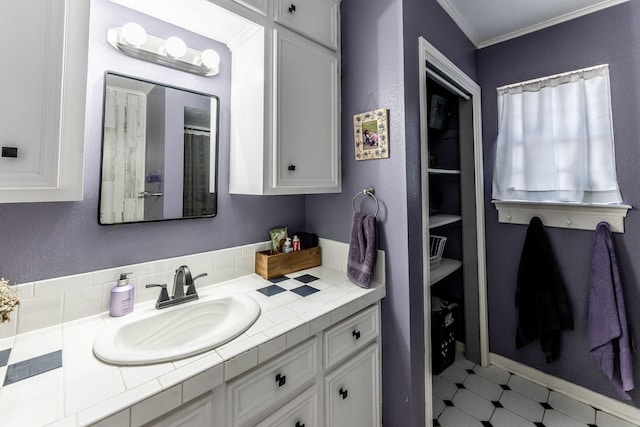 full bathroom with vanity, crown molding, and tile patterned floors