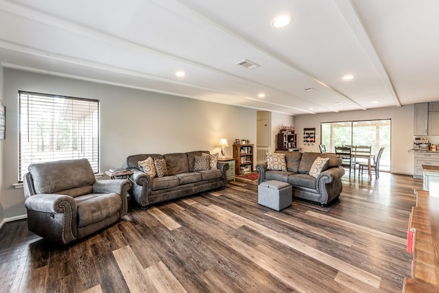 living area featuring visible vents, recessed lighting, dark wood-style flooring, and beamed ceiling