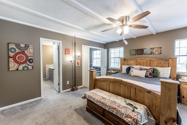 bedroom with baseboards, ceiling fan, light carpet, and ensuite bath