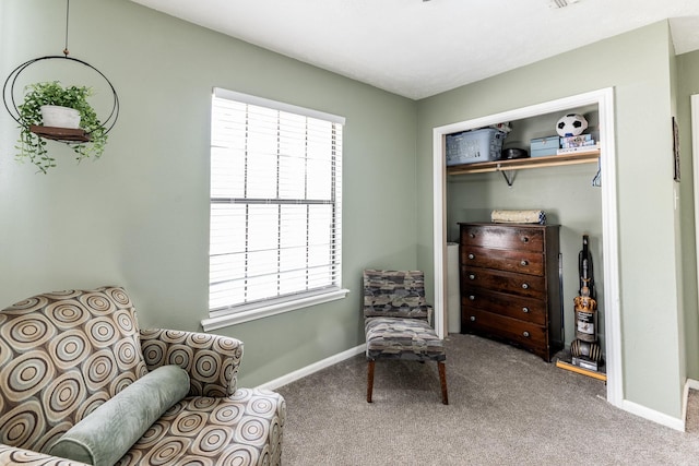 sitting room featuring carpet floors and baseboards