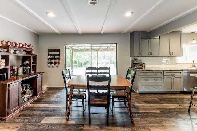 dining room featuring beamed ceiling, visible vents, and dark wood-type flooring