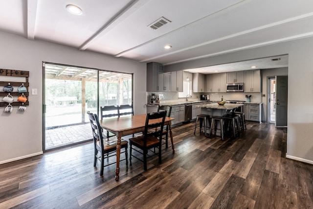 dining room with baseboards, dark wood-type flooring, and visible vents