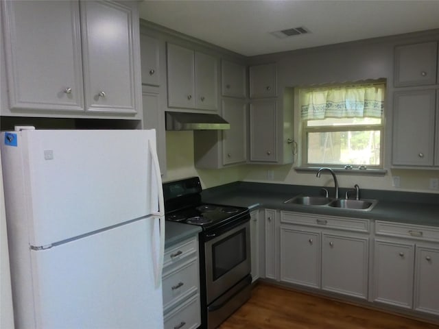 1429 Fish Hatchery Rd, Huntsville, TX 77320 - kitchen with a sink, freestanding refrigerator, stainless steel electric range, visible vents, and under cabinet range hood