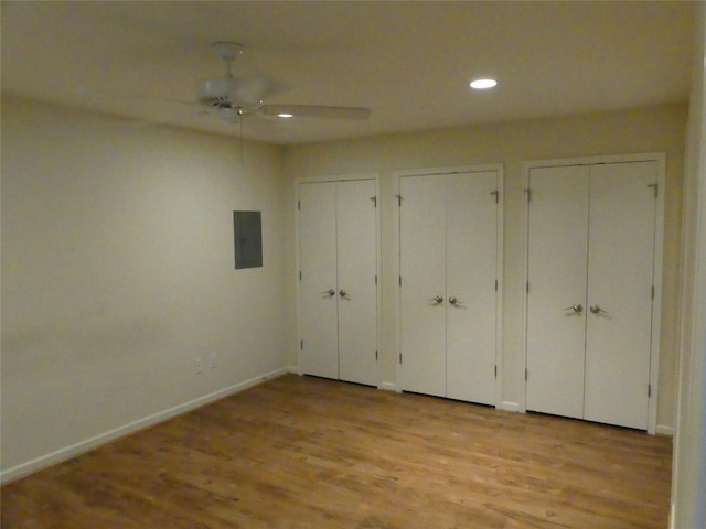 1429 Fish Hatchery Rd, Huntsville, TX 77320 - unfurnished bedroom featuring multiple closets, light wood-style flooring, recessed lighting, baseboards, and electric panel