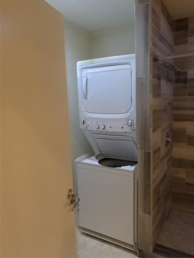 1429 Fish Hatchery Rd, Huntsville, TX 77320 - laundry room featuring laundry area, stacked washer and clothes dryer, and light tile patterned floors