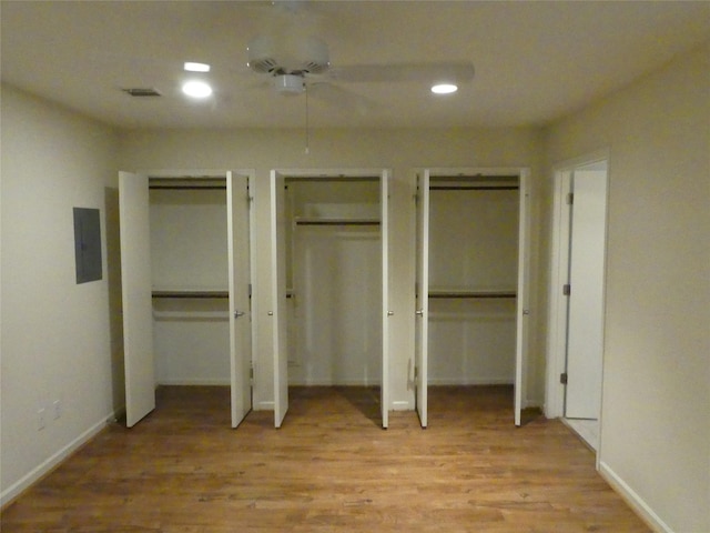1429 Fish Hatchery Rd, Huntsville, TX 77320 - unfurnished bedroom with recessed lighting, visible vents, electric panel, multiple closets, and light wood-type flooring