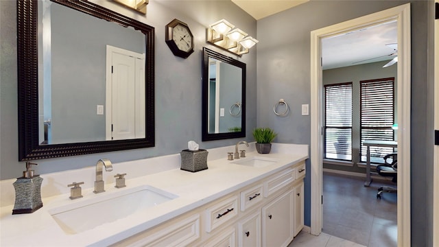 12708 Pelican Blvd, Willis, TX 77318 - full bathroom featuring double vanity, a ceiling fan, tile patterned floors, and baseboards