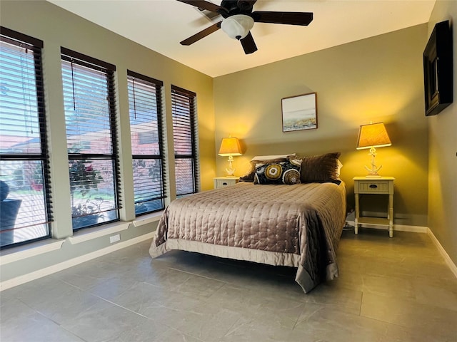 12708 Pelican Blvd, Willis, TX 77318 - tiled bedroom with baseboards and ceiling fan