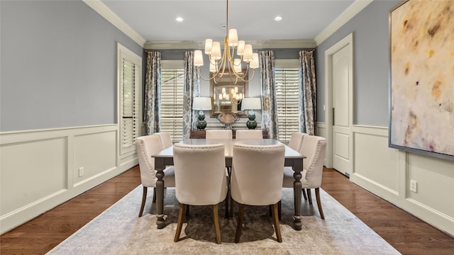 dining area with a notable chandelier, a decorative wall, ornamental molding, and wainscoting