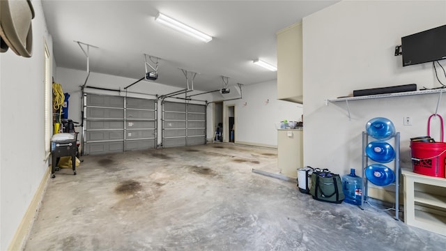 garage with baseboards and a garage door opener