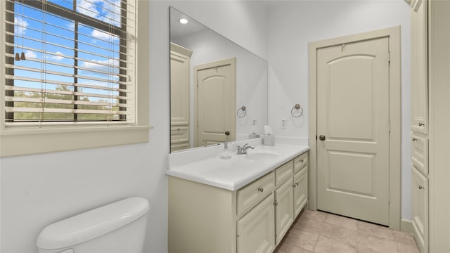 bathroom featuring toilet and vanity