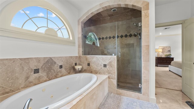 ensuite bathroom featuring a shower stall, connected bathroom, a jetted tub, visible vents, and tile patterned flooring