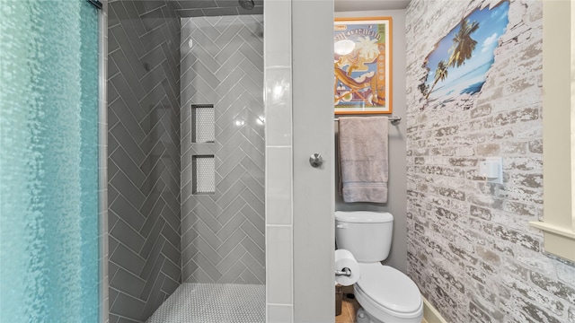 bathroom with a shower stall and toilet
