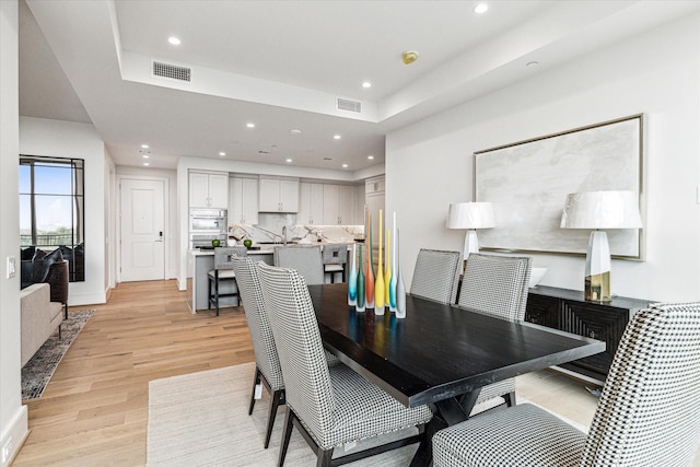 5656 San Felipe St Unit 603, Houston, TX 77056 - dining space with a raised ceiling, light wood-style floors, visible vents, and recessed lighting