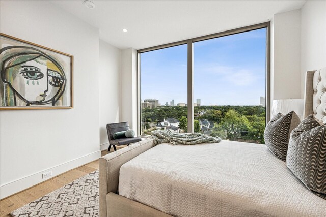 5656 San Felipe St Unit 603, Houston, TX 77056 - bedroom with recessed lighting, expansive windows, wood finished floors, and baseboards