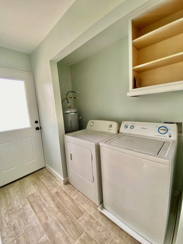 laundry area with washer and dryer, water heater, light wood finished floors, baseboards, and laundry area