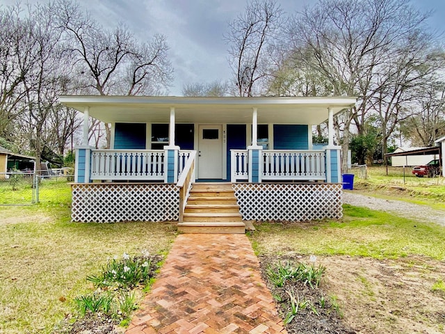 bungalow-style house featuring a porch, a front lawn, and fence