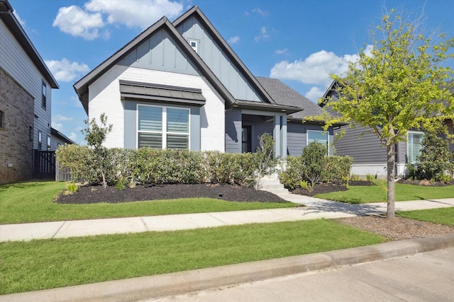 view of front of home featuring board and batten siding and a front lawn