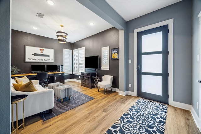 living room with baseboards, wood finished floors, visible vents, and recessed lighting