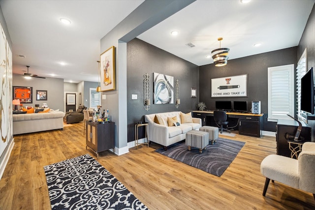 living room with ceiling fan, light wood-style flooring, baseboards, visible vents, and recessed lighting