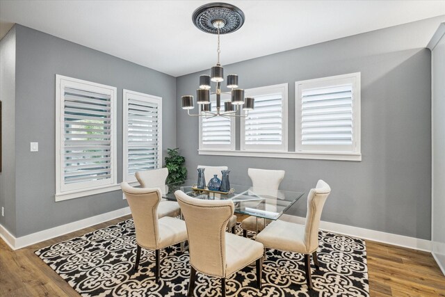 15807 Celebration Ln, Cypress, TX 77433 - dining room featuring a chandelier, baseboards, and wood finished floors