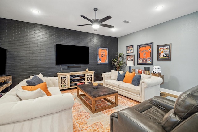 living area featuring a ceiling fan, wood finished floors, baseboards, visible vents, and recessed lighting