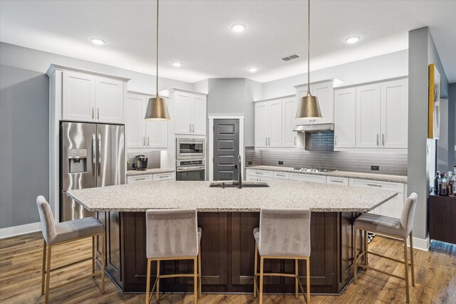 15807 Celebration Ln, Cypress, TX 77433 - kitchen with stainless steel appliances, a sink, decorative backsplash, a large island, and recessed lighting
