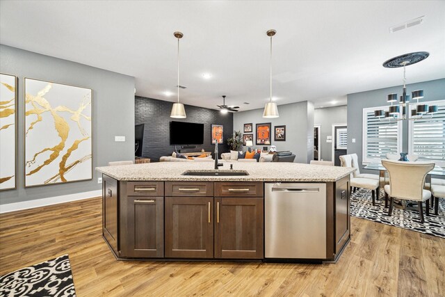 15807 Celebration Ln, Cypress, TX 77433 - kitchen with dishwasher, a sink, open floor plan, light wood-style floors, and dark brown cabinetry