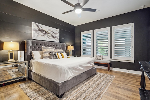 bedroom featuring baseboards, a ceiling fan, and wood finished floors