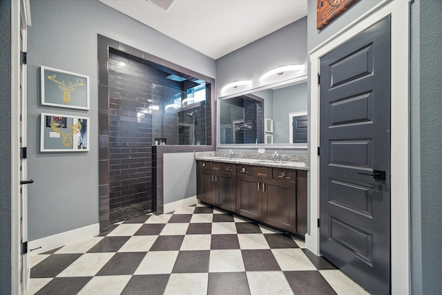 bathroom featuring walk in shower, a sink, double vanity, and visible vents