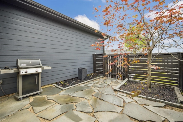 view of patio / terrace featuring fence and a grill