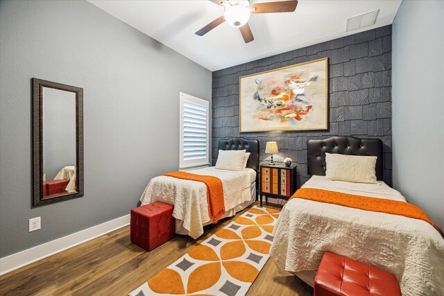 15807 Celebration Ln, Cypress, TX 77433 - bedroom with wood finished floors, baseboards, an accent wall, a ceiling fan, and vaulted ceiling