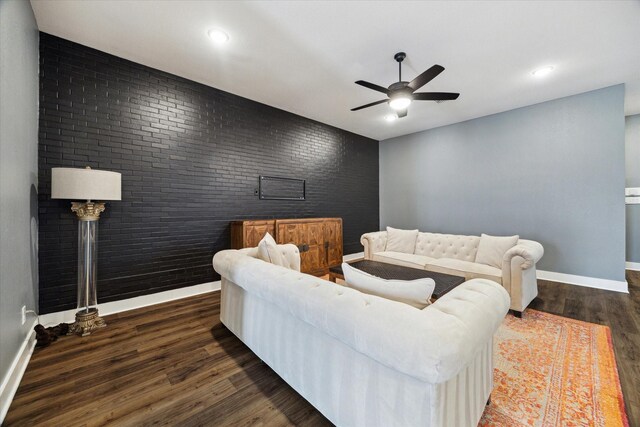 15807 Celebration Ln, Cypress, TX 77433 - living room with brick wall, ceiling fan, wood finished floors, baseboards, and an accent wall