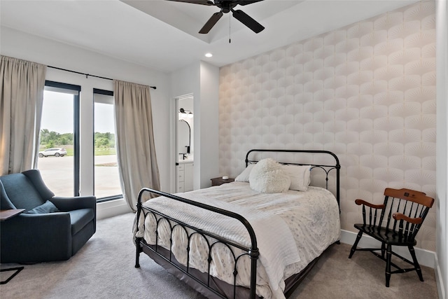 carpeted bedroom featuring ensuite bathroom, baseboards, recessed lighting, and multiple windows