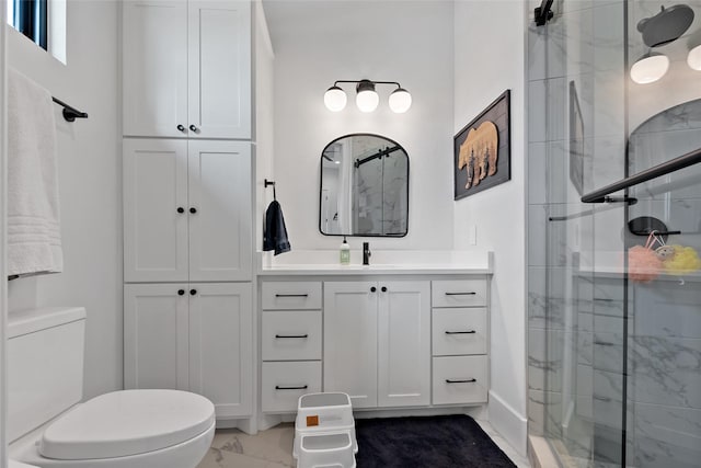 bathroom featuring vanity, marble finish floor, a shower stall, and toilet