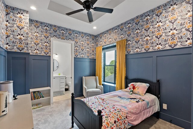 bedroom featuring carpet, a decorative wall, and wainscoting