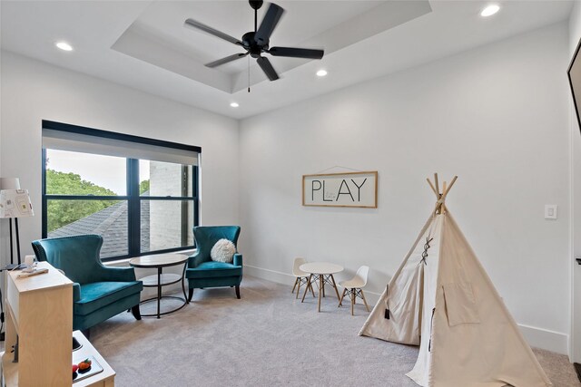 sitting room featuring baseboards, carpet, recessed lighting, ceiling fan, and a raised ceiling