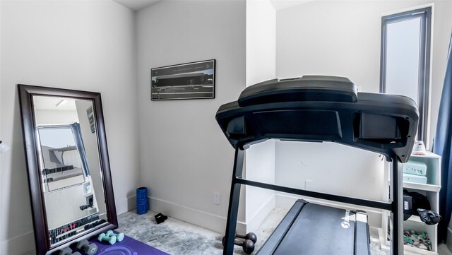workout area featuring baseboards