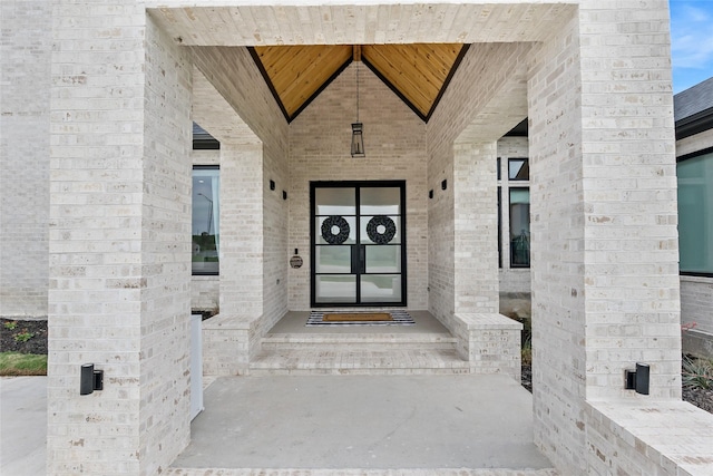 view of exterior entry with brick siding