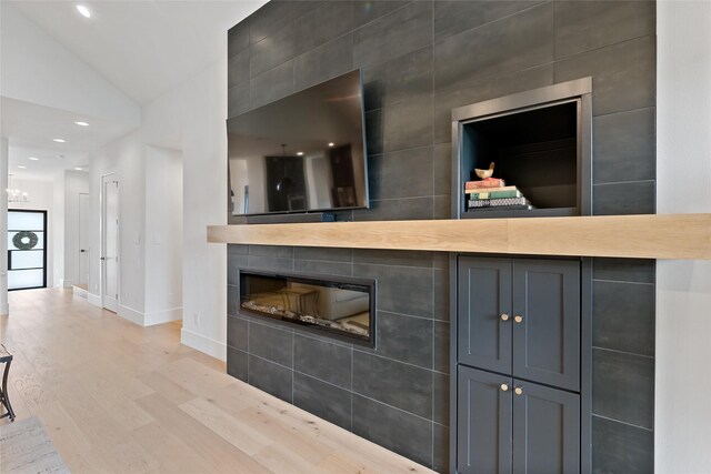 details featuring recessed lighting, baseboards, wood finished floors, and a fireplace