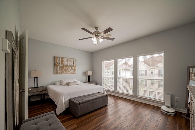 bedroom with a ceiling fan and dark wood-style flooring