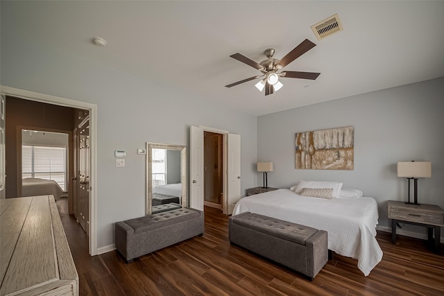bedroom featuring wood finished floors, visible vents, baseboards, and ceiling fan