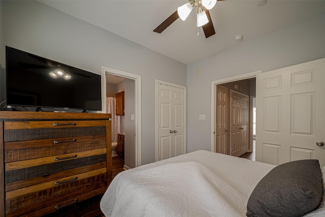 bedroom with a ceiling fan, wood finished floors, and ensuite bathroom