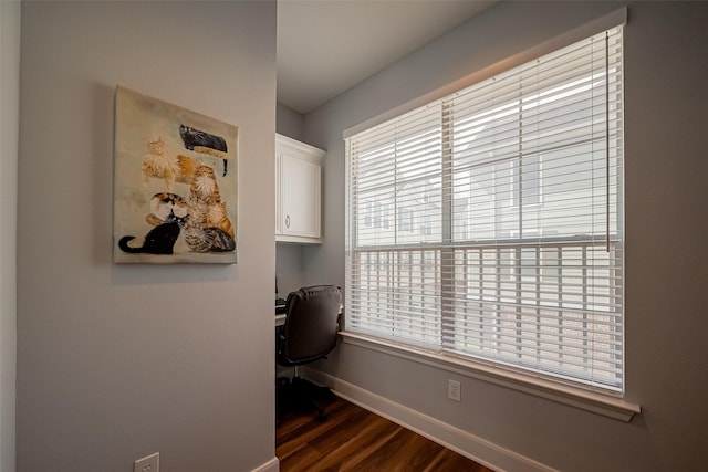 office space featuring plenty of natural light, baseboards, and dark wood-style flooring