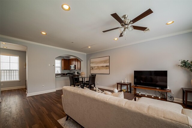 living area featuring plenty of natural light, arched walkways, and recessed lighting