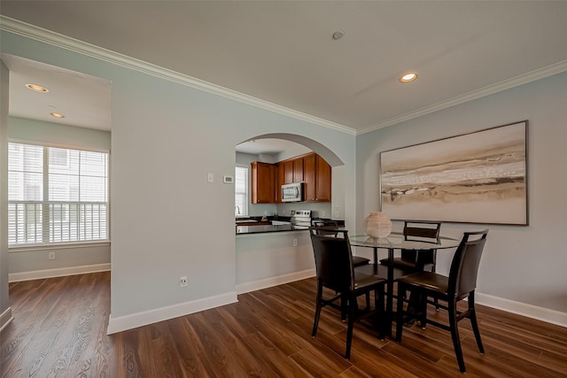 dining area featuring baseboards, arched walkways, dark wood finished floors, and crown molding