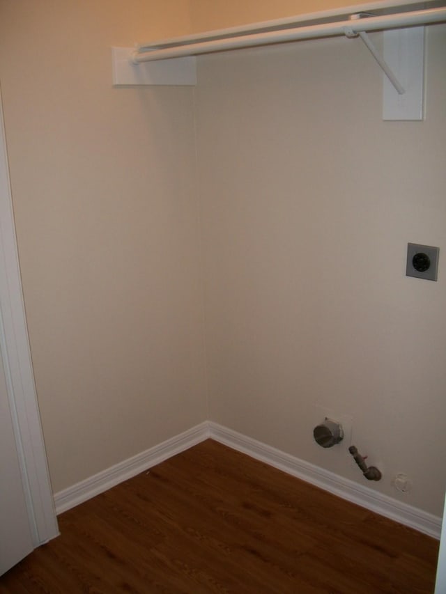 laundry area with baseboards, hookup for a gas dryer, dark wood-style floors, and electric dryer hookup